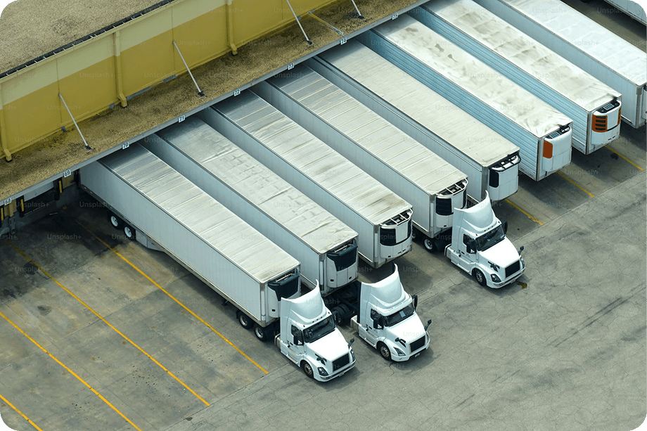 Aerial view of freight trucks parked at loading docks