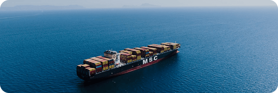 Container ship sailing across open sea