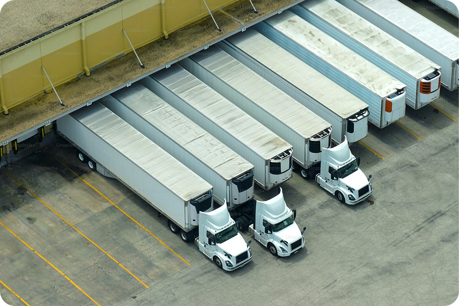 Aerial view of freight trucks parked at loading docks